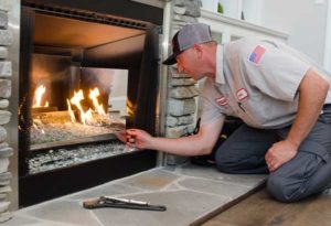 service tech fixing a fireplace
